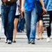 legs of people in jeans crossing road