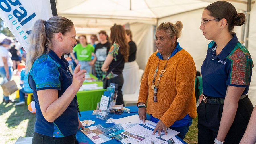 Photo of 3 Legal Aid Queensland staff members at NAIDOC Musgrave Park