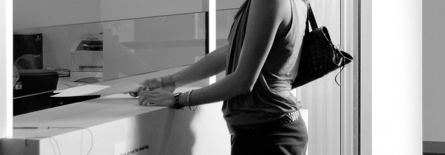 A photo of a woman at a service desk.